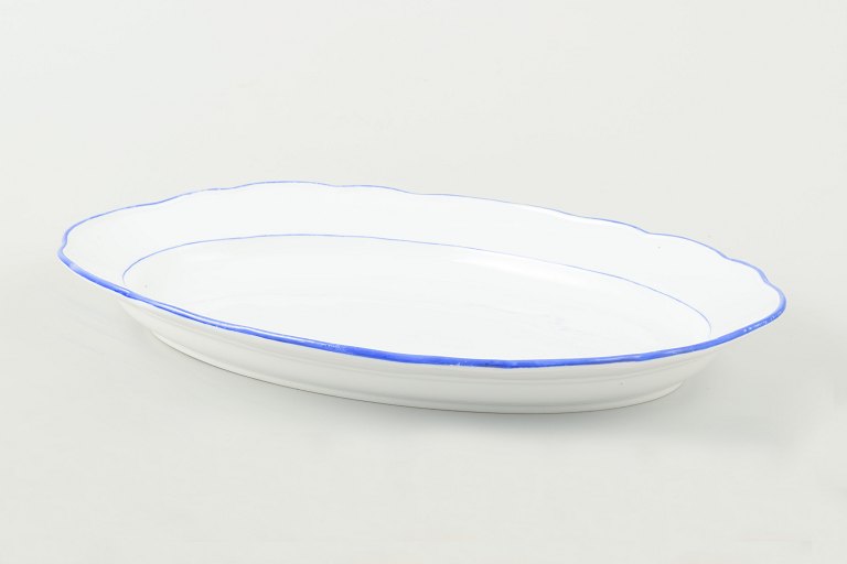 MeissenServing platter in white-glazed porcelain with scalloped rim and blue trim.
